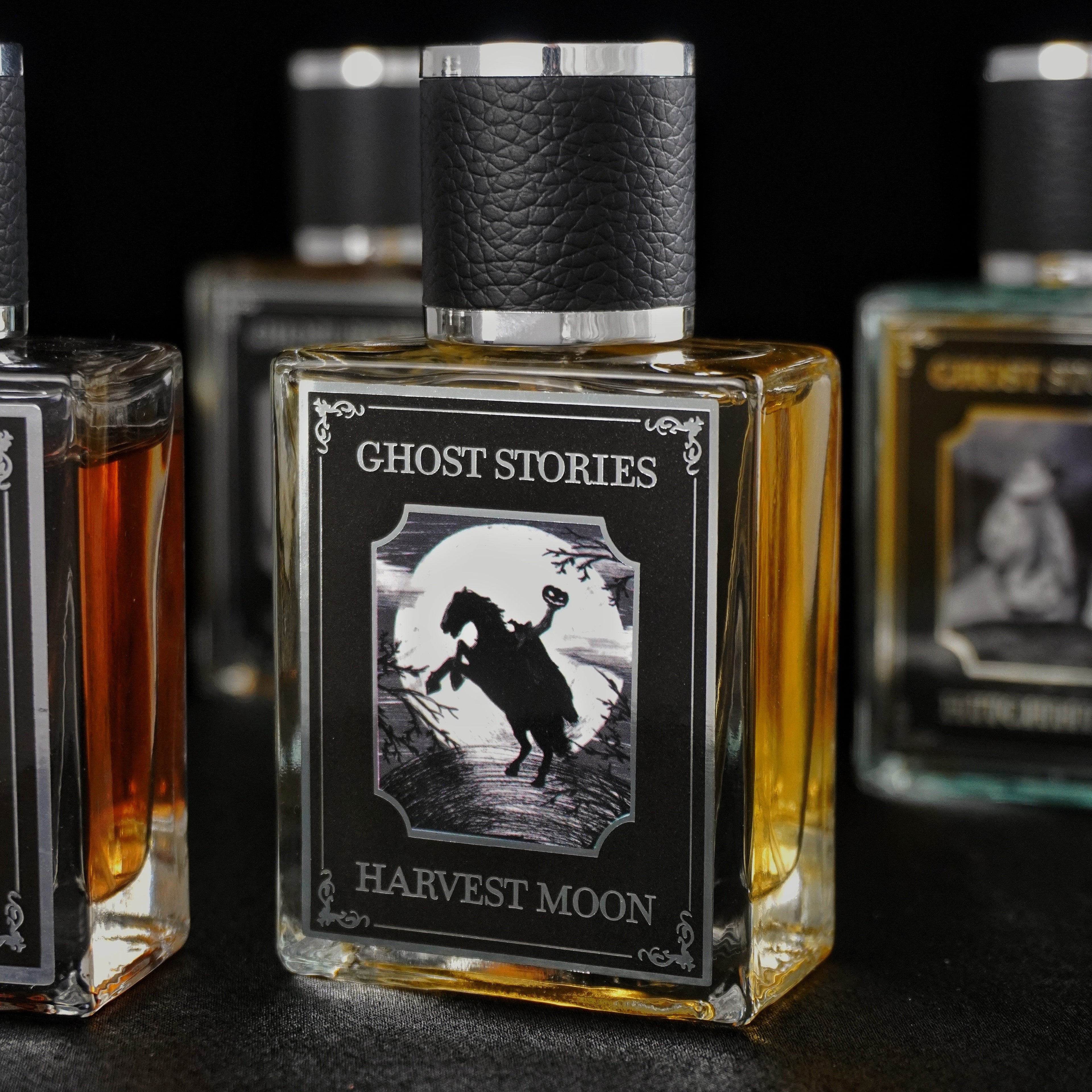 Perfume bottle with Ghost Stories Hitchhiker on it with a black velvet background.