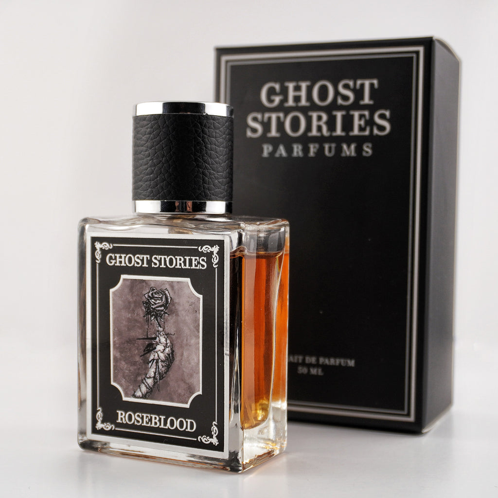 Perfume bottle labeled 'Ghost Stories Roseblood' with a matching box on a white background
