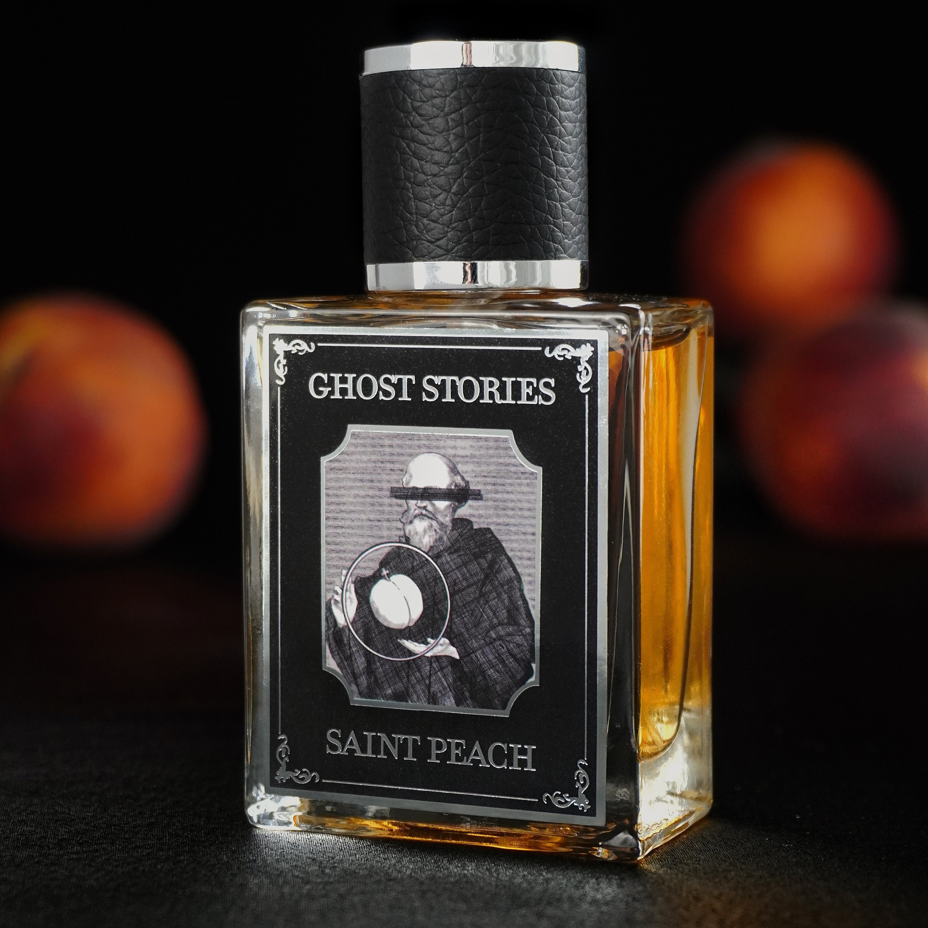 Perfume bottle labeled 'Ghost Stories Saint Peach' with peaches in the background